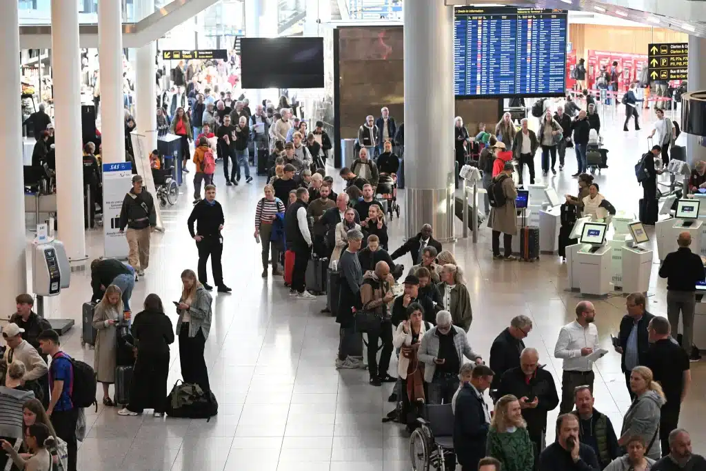 Passengers lining up to get new tickets at the Copenhagen Airport on 16 September - Getty Images