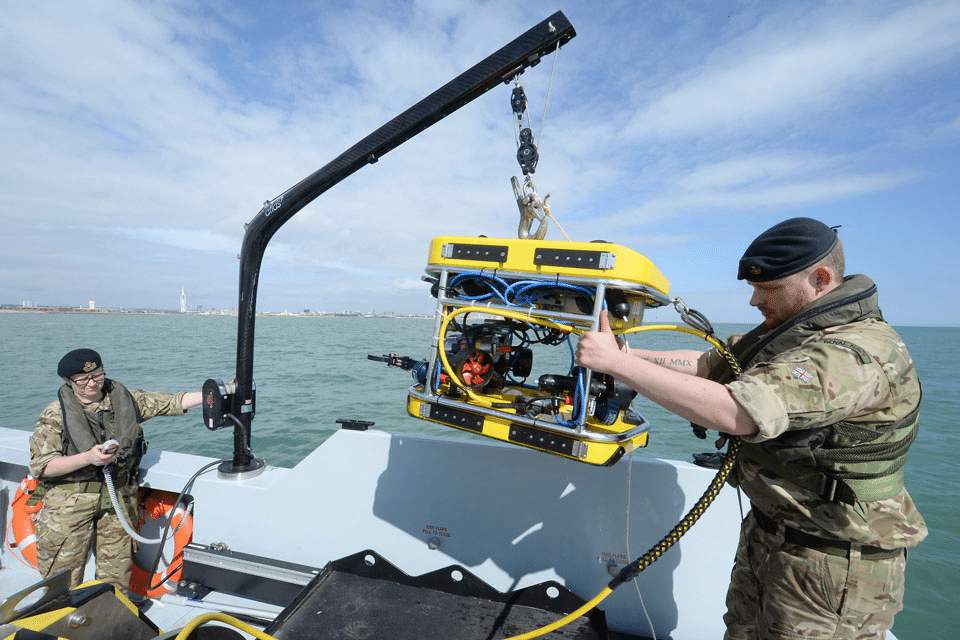 The Royal Navy is focusing on integrating drones for mine countermeasures, including Atlas ARCIMS systems and Sea-class USVs for mine detection. Trials are underway for drone carrier ships, and drone data is being integrated into the command and control systems of Class 26 and 31 ships. The goal is to remove crews from high-risk minefields while maintaining coverage.